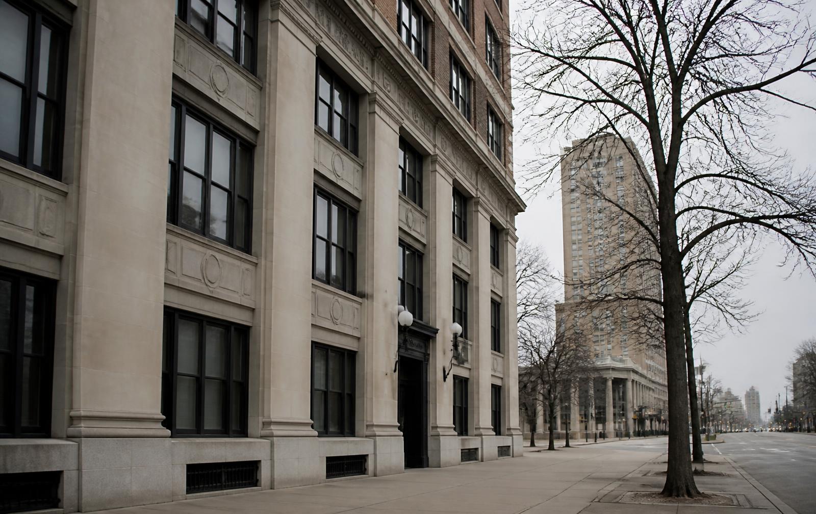 Early-morning street view of limestone and brick buildings in Detroit's New Center district